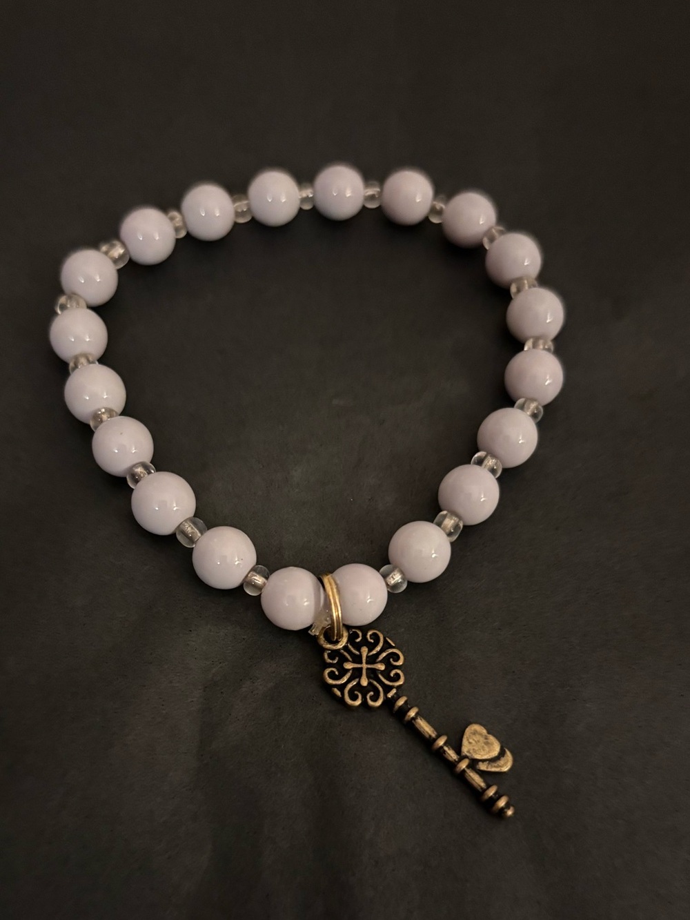 Grey Beaded Stretch Bracelet with Antique Gold Key Charm